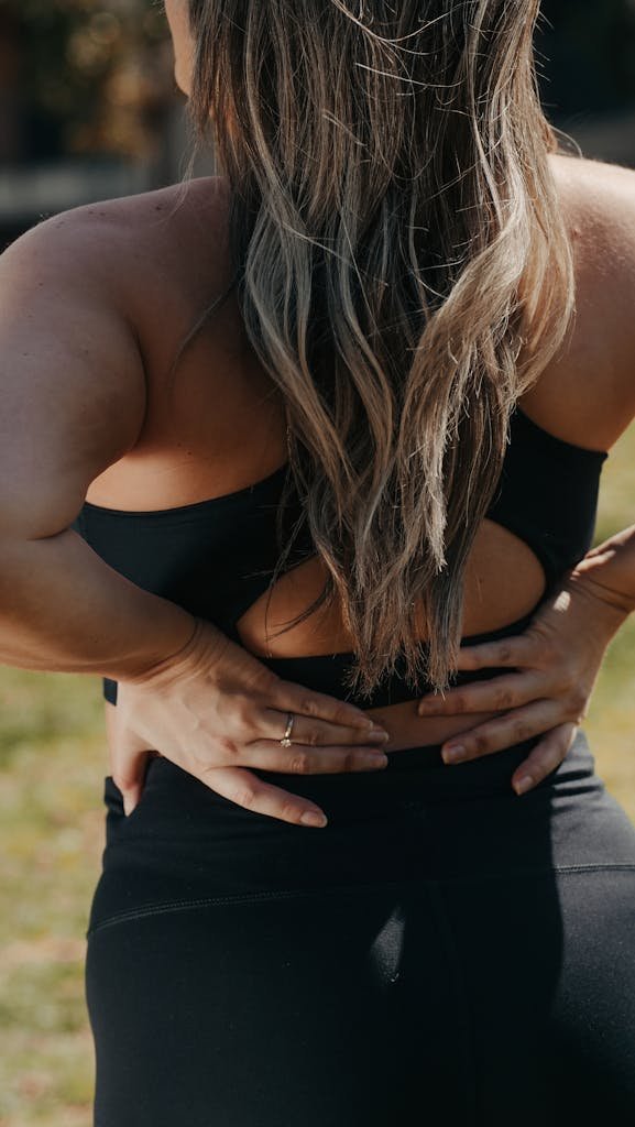 A Woman Touching Her Back