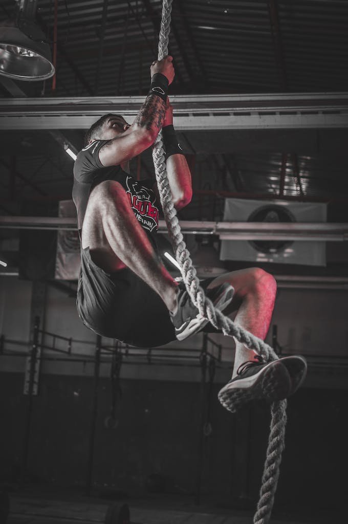 Man Climbing on Rope